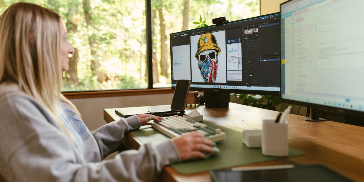 Complete Team Outfitter employee designing custom art