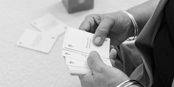 Person holding and looking at question cards.