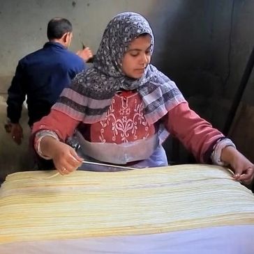 Woman making papyrus paper