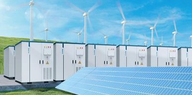 Solar panels and wind turbines generating renewable energy with battery storage units.