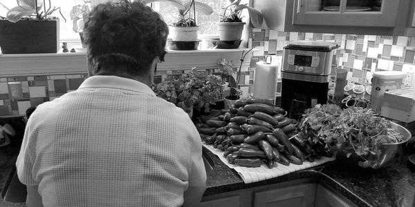 South American grandmother preparing salsa ingredients