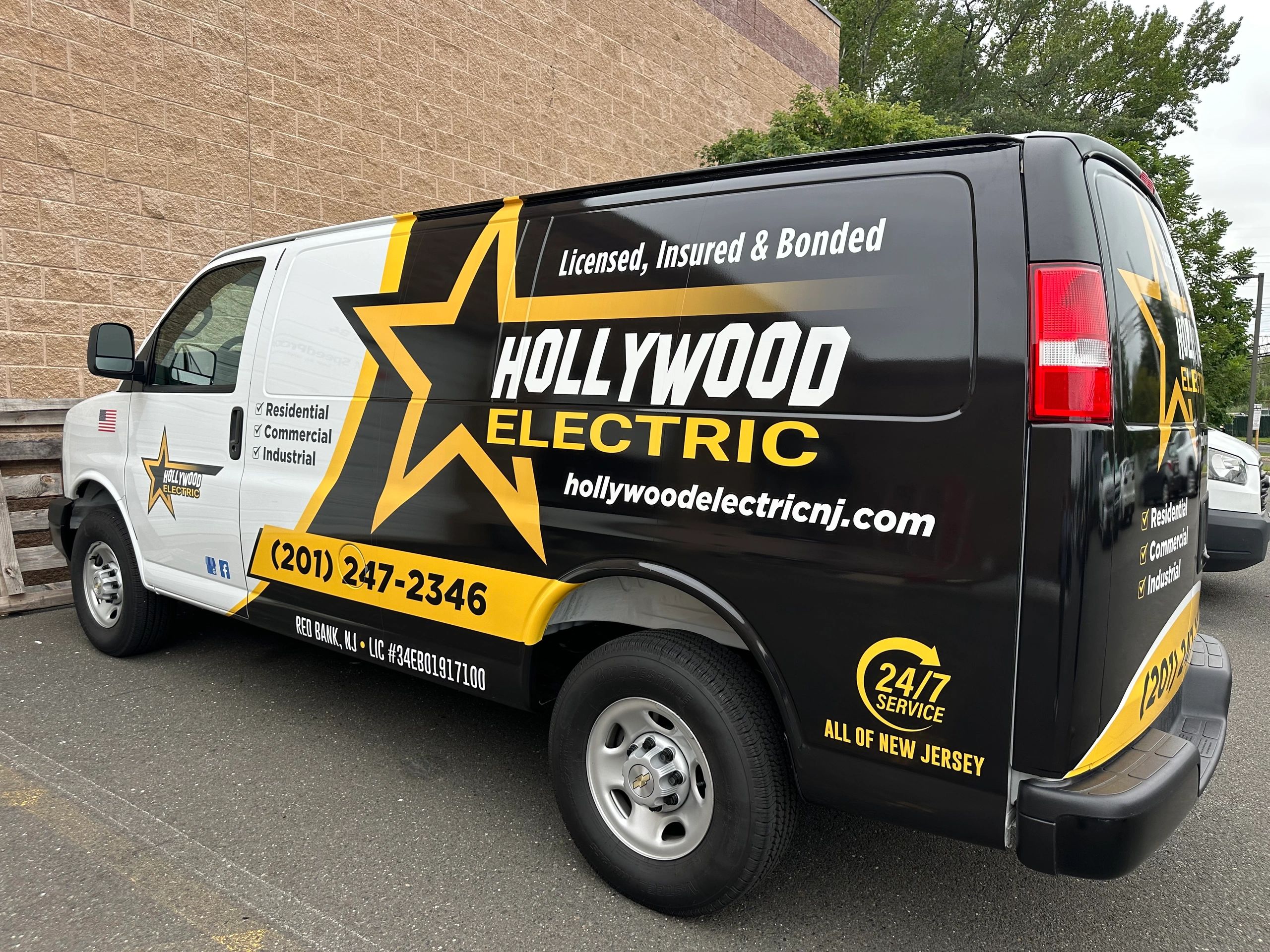 Hollywood Electric service van with bold black and yellow branding.