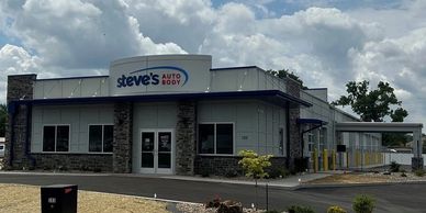Steve's Auto Body shop building under a cloudy sky.