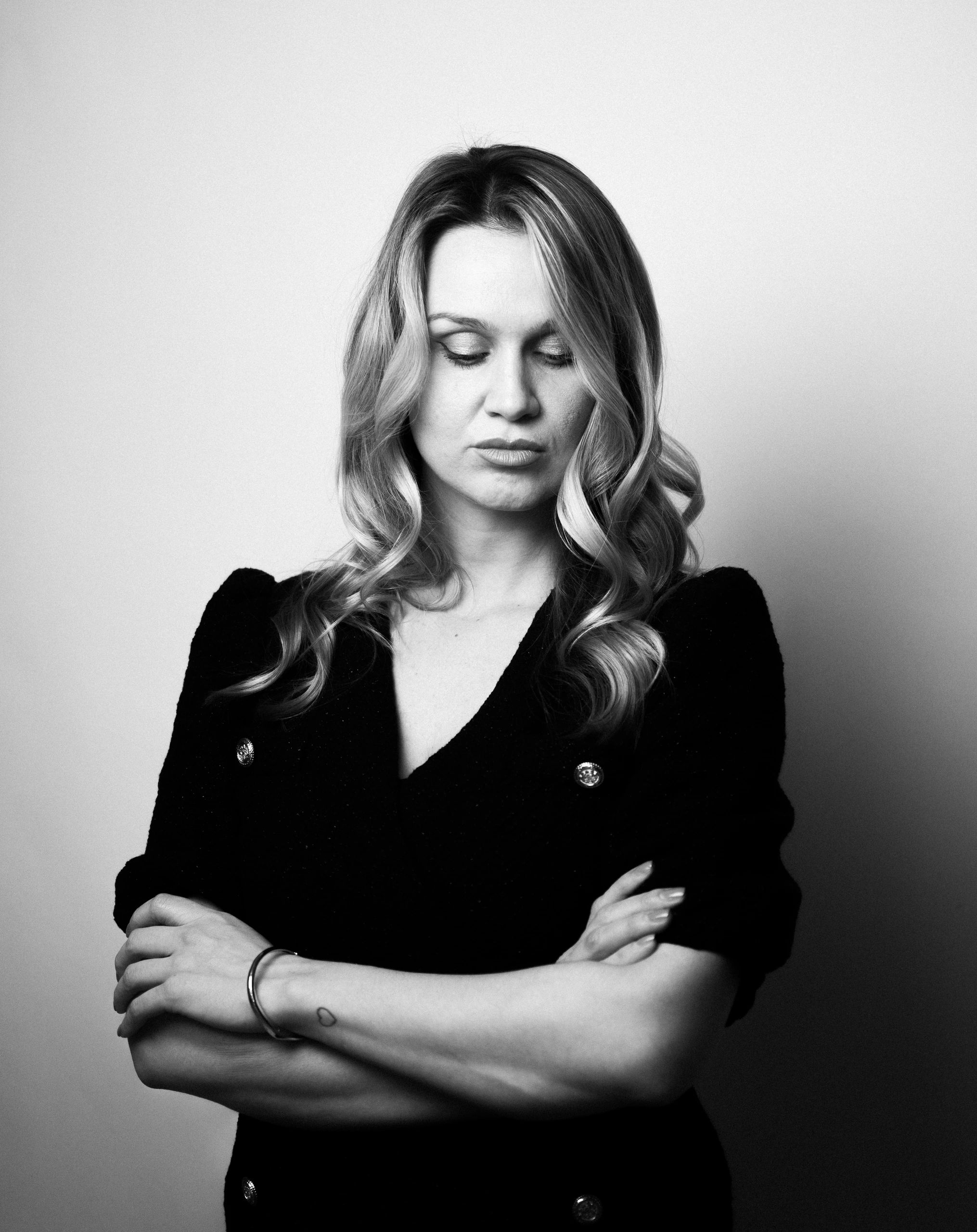 Black and white photo of a woman looking down.