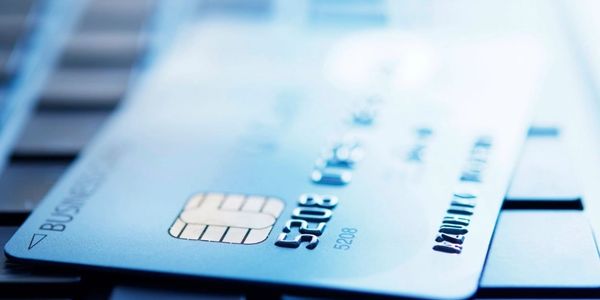 Close-up of a credit card on a laptop keyboard.