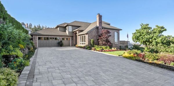 Spacious driveway leading to a modern house.