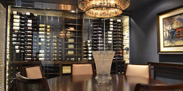 Contemporary glass enclosed wine cellar with cooling. 