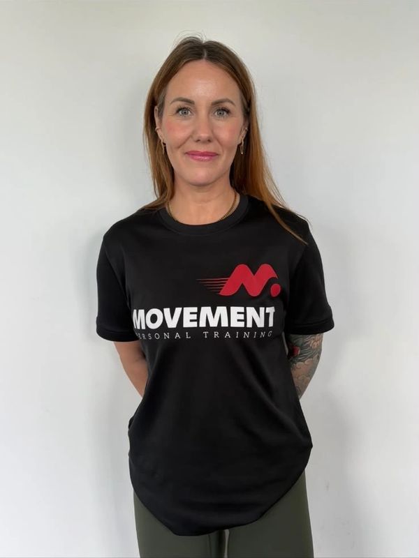 Woman wearing a black Movement Personal Training t-shirt.