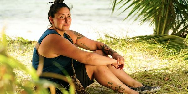 Karla Cruz Godoy sitting on the beach of Fiji Islands. Photo by Robert Voets/CBS