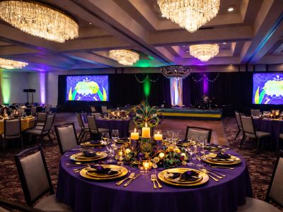 Elegant banquet hall setup with round tables and chandeliers.