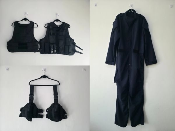 Black tactical gear hanging on a wall.