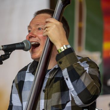 Man singing and playing a string instrument.
