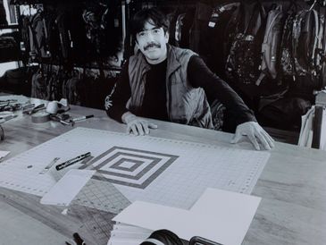 Rey black and white photo sitting at a table for work 