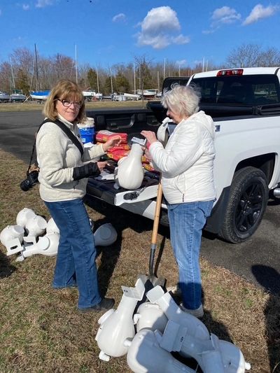 Marla Burke and Pat DeWald apply labels to the new purple martin house at Lake Nockamixon.