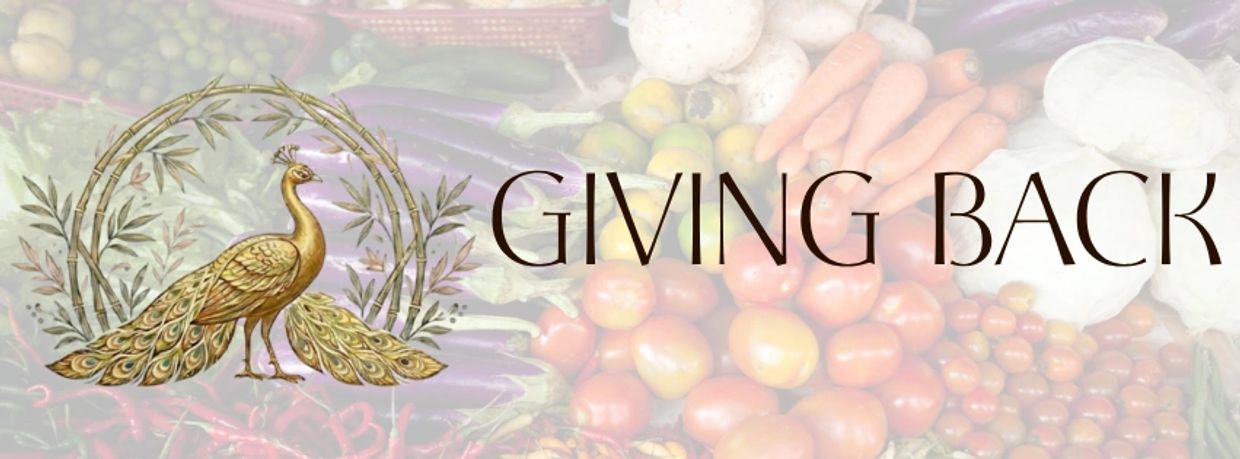 Elegant peacock logo with 'Giving Back' text over fresh vegetables background.
