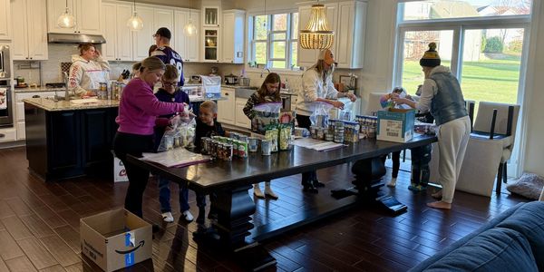 My neighbors packing boxes at my house for the food pantry
