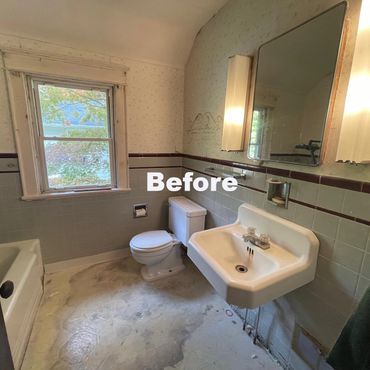 Old bathroom with worn flooring and outdated fixtures.