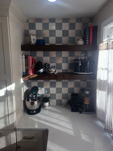 Cozy kitchen corner with wooden shelves, mixer, and coffee maker.