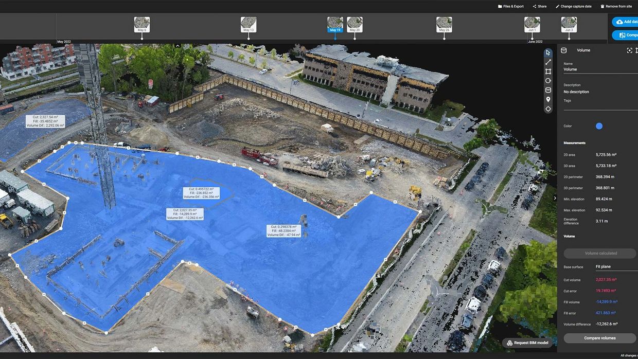 3D construction site model with volume analysis and measurements in blue overlay.