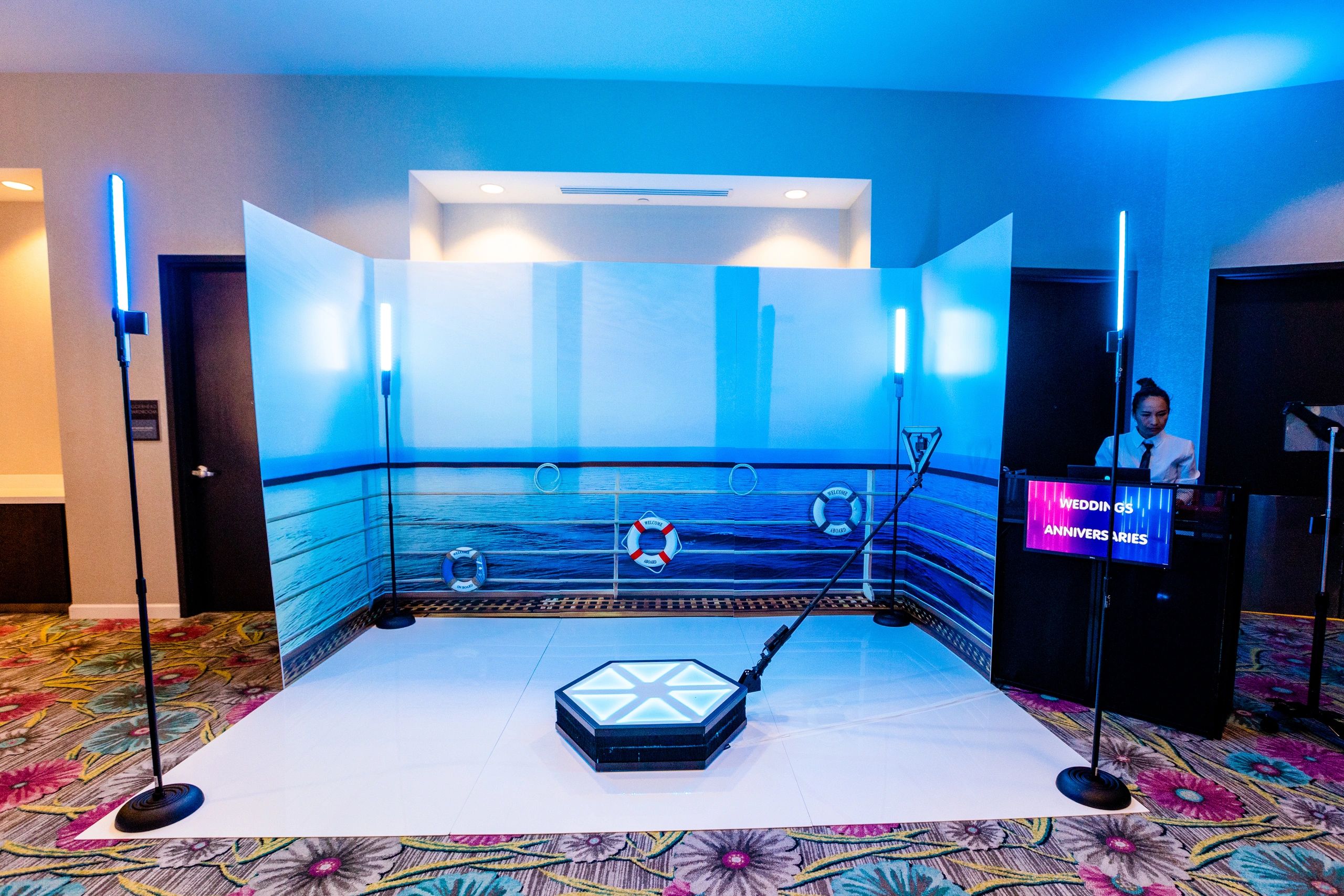 Elegant event photo booth with ocean theme and blue lighting.