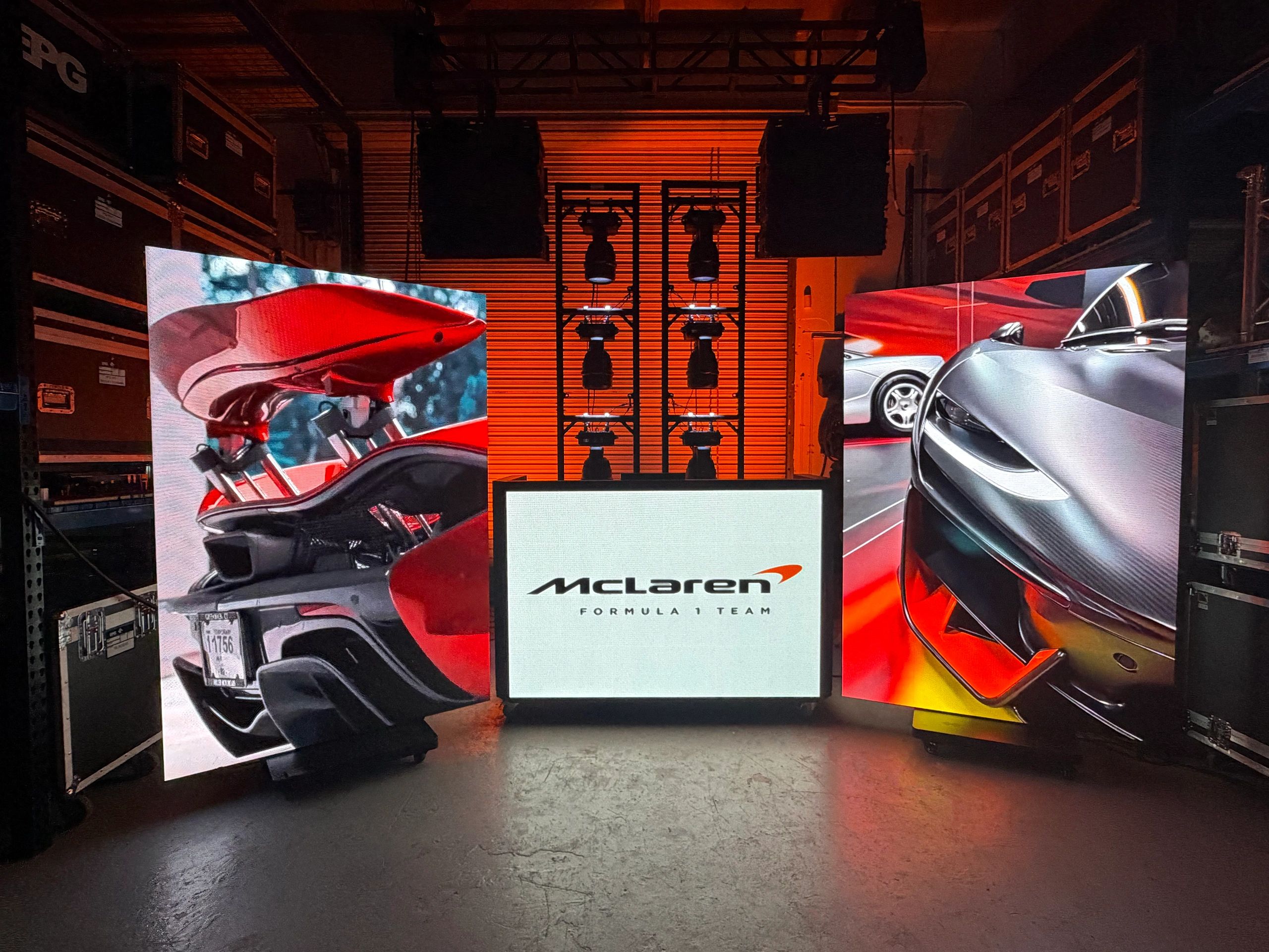 McLaren Formula 1 Team display with car images and lighting setup.