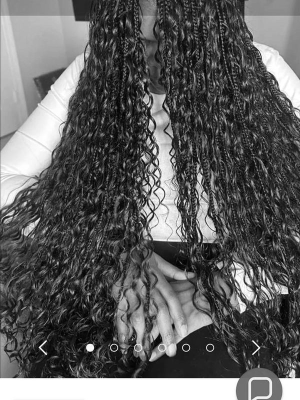 Long curly and braided hairstyle from Hair City by Consty Beauty.