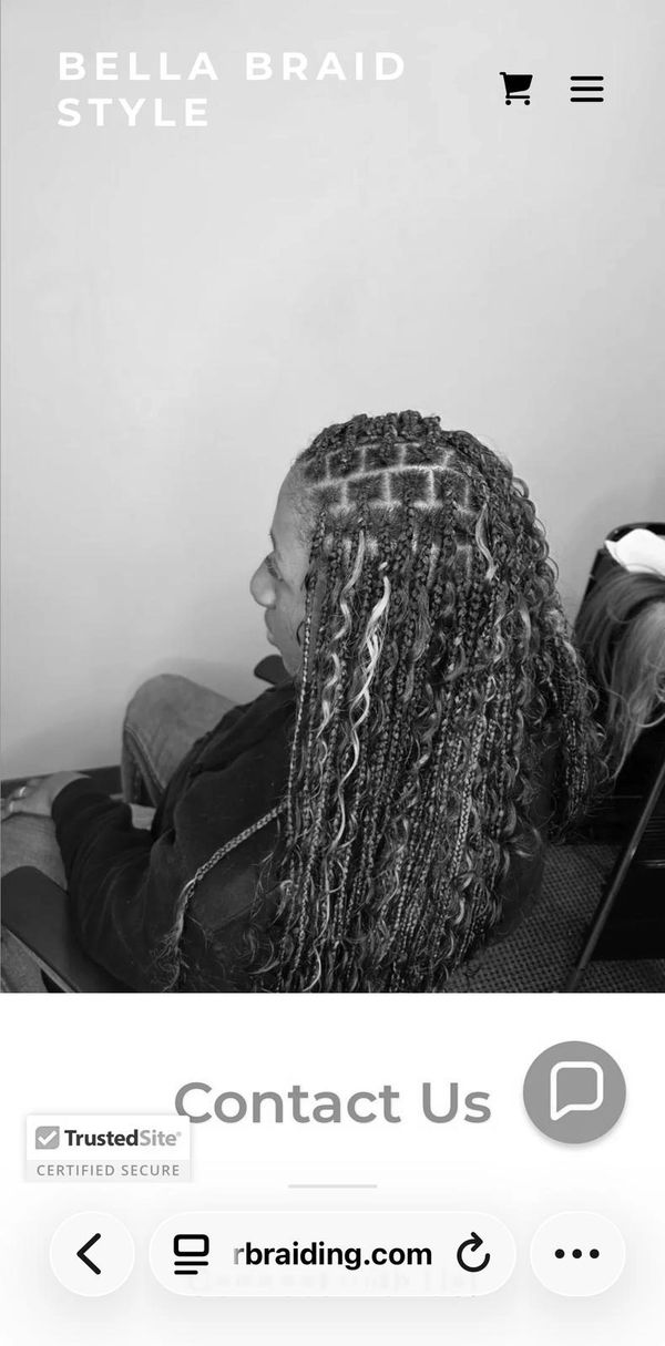 Intricate braided hairstyle with highlighted curls at Bella Braid Style.