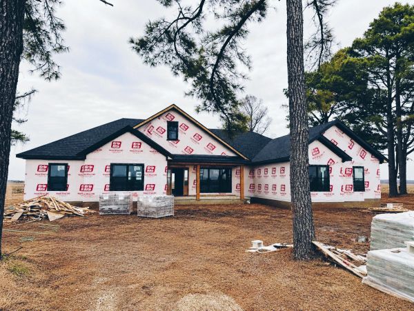 New house under construction with wrap sheeting.
