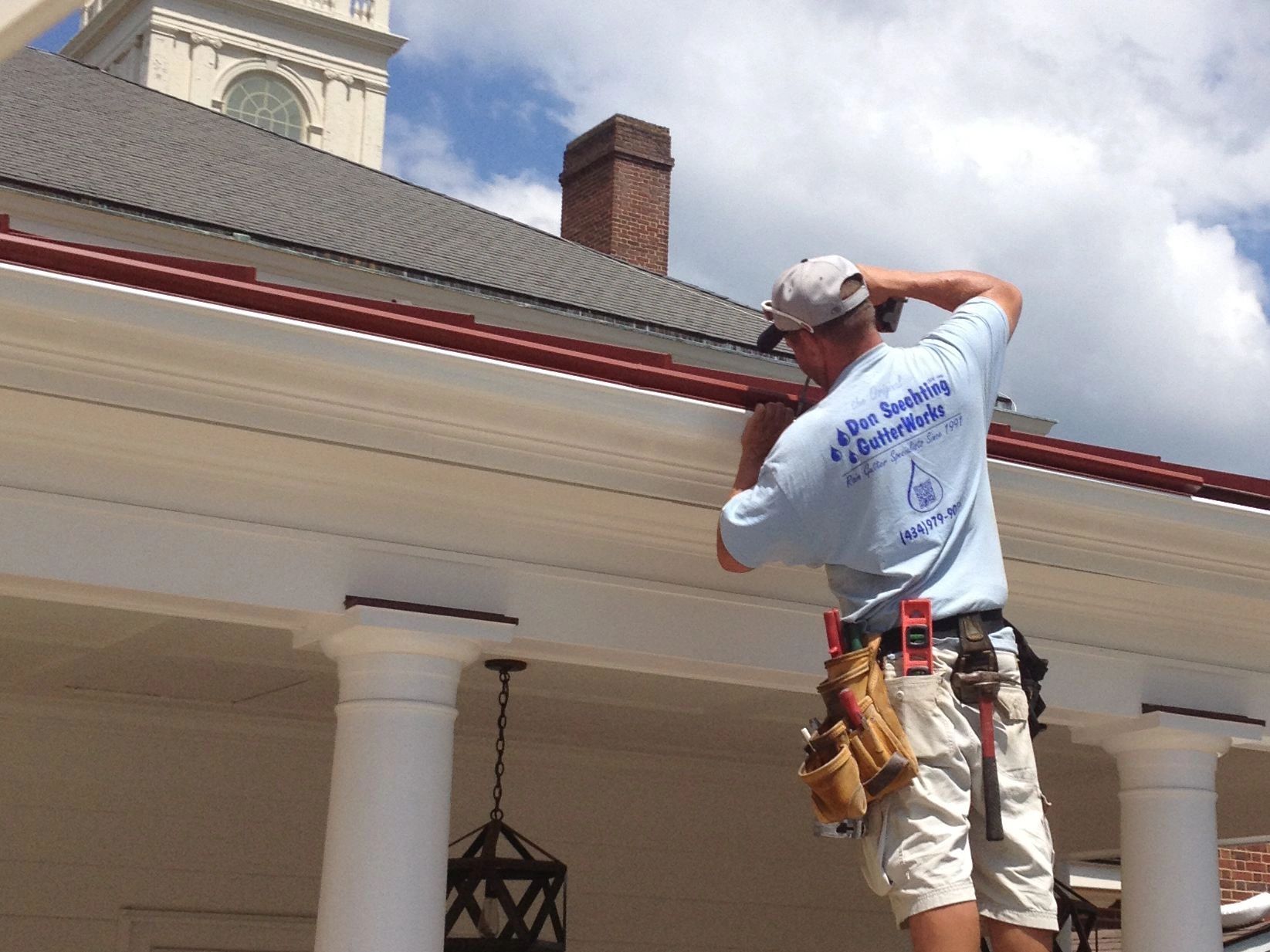 Seamless gutters and gutter guards installed on historic Social Hall in Charlottesville, Virginia.