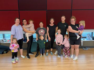 Group of women with children indoors.