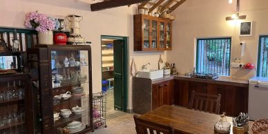 Cozy kitchen with wooden furniture and glass cabinet.