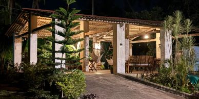 Outdoor patio area with seating and lights at night.