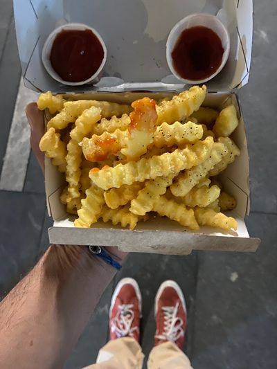Crinkle-cut French Fries and Ketchup looking like eyes and a mouth. Red Converse One-Stars.