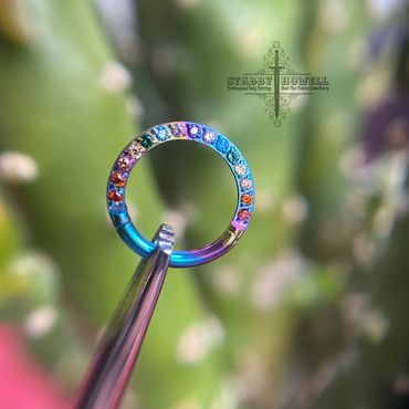 LGBT clicker ring made from titanium that has been iodised 