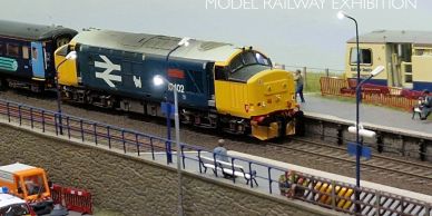 Model railway with detailed train and station.