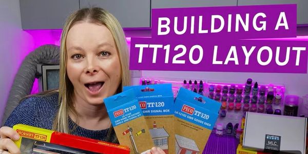 Woman showing TT120 model railway kits with a caption about building a layout.