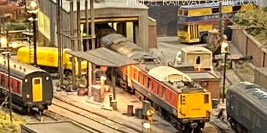 Model railway exhibition with detailed trains and tracks.