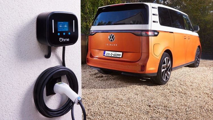 OHMe Home Pro EV charger unit installed on an exterior wall, a smart and compact home electric vehicle charging solution.