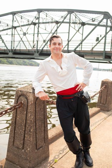 Man in a historical outfit by the river.