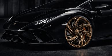 Sleek black Velara Hellix-X sports car with striking gold wheels.