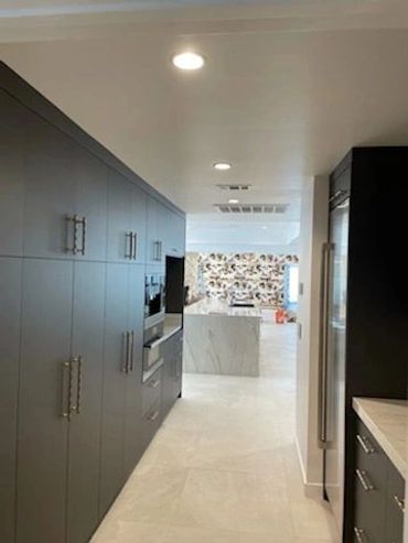 Wall of tall dark pantry cabinets