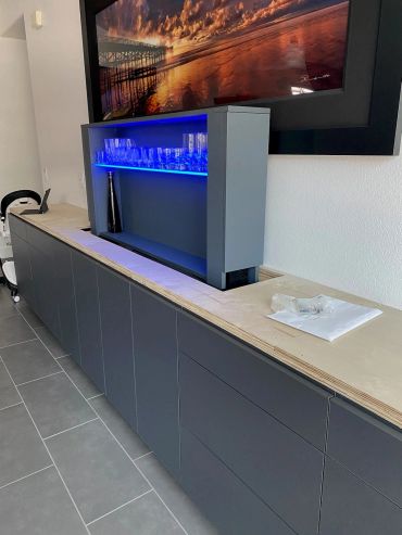 Dark media cabinet with lighted TV lift