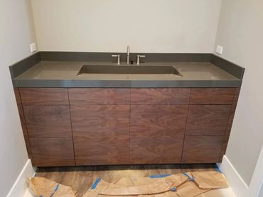 Walnut vanity with integrated gray sink top