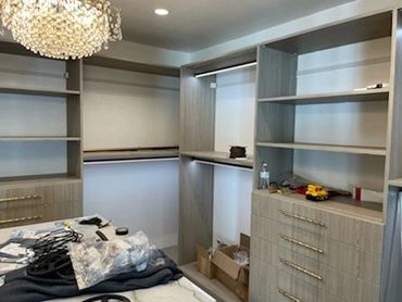 Walk-in closet with open shelving and drawers