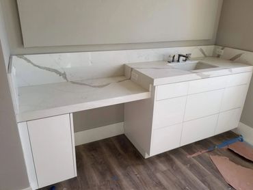 White vanity with marble top and makeup desk