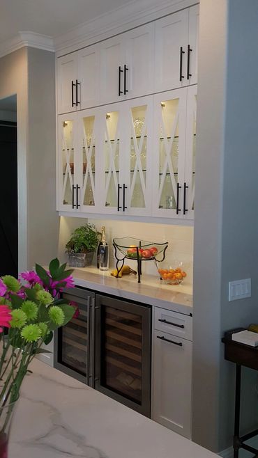White built-in bar with glass uppers and wine fridge