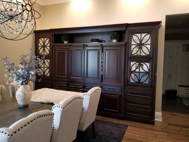 Dark wood entertainment center with decorative glass doors
