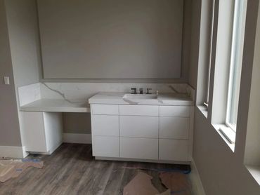 White vanity and makeup desk with marble top