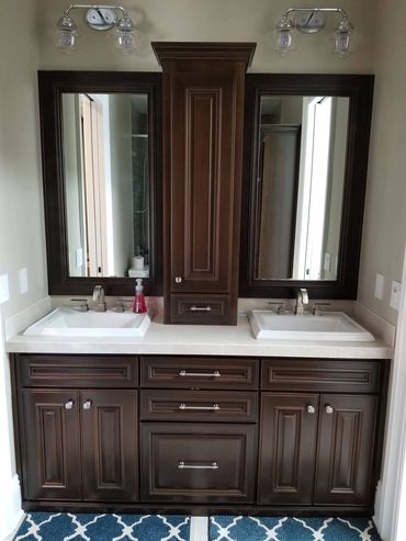 Dark wood double vanity with center tower