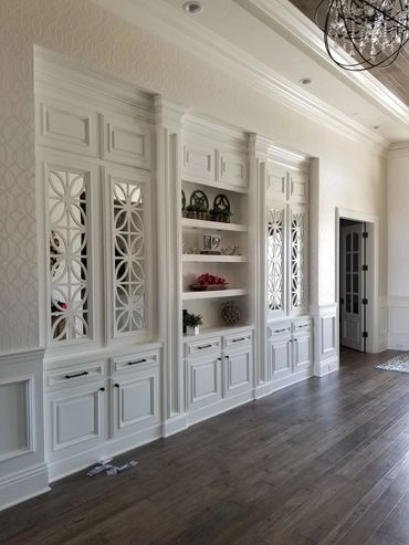White built-in wall cabinets with decorative glass doors